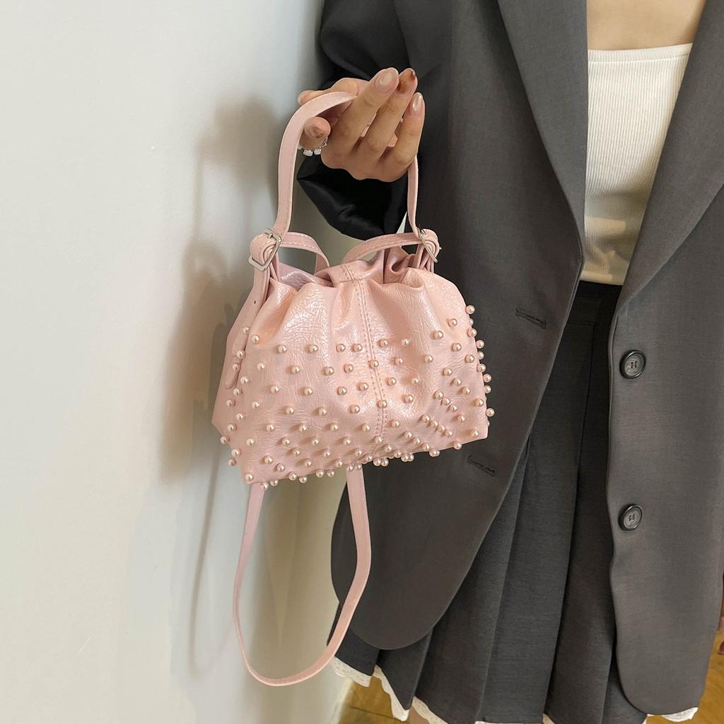Trend European and American fashion rivets spring and summer armpit women's bags simple and versatile portable bucket bags single shoulder oblique spa
