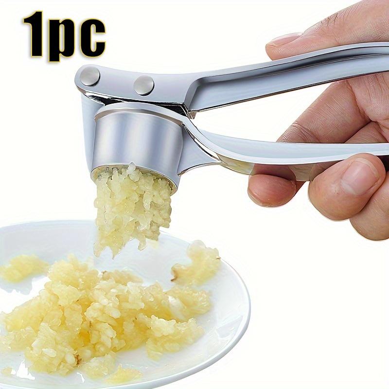 A metal garlic press Manual Garlic Press Handheld Ginger and Garlic Kitchen Tool 1