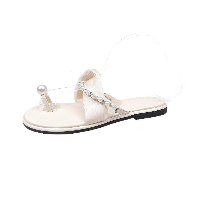 

2025 summer new round-toed muffin, seaside beach platform slippers, a woman wearing a pair of pearl sandals 35