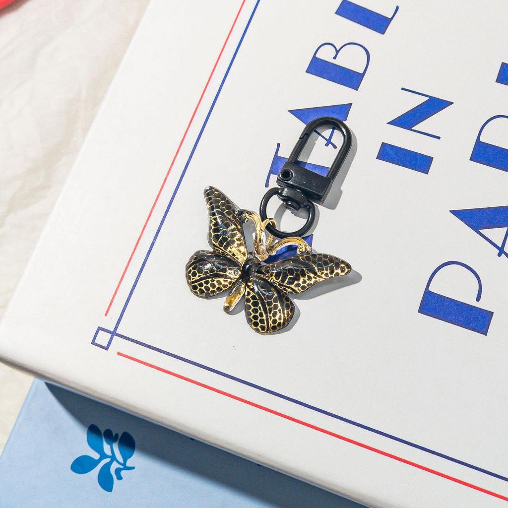 Gradient Butterfly Pendant: Iridescent Keychain Charm for Backpack or Earphone Case.