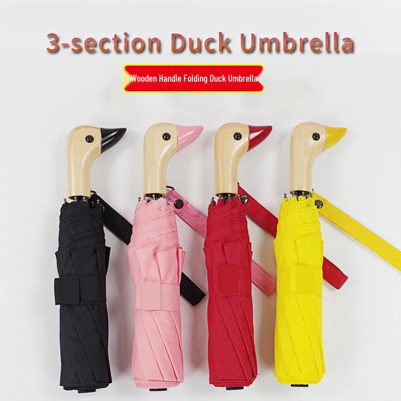 Cute Three-Fold Duck Head Umbrella: Cartoon Design, Wooden Handle, Solid Color for Rain or Shine.