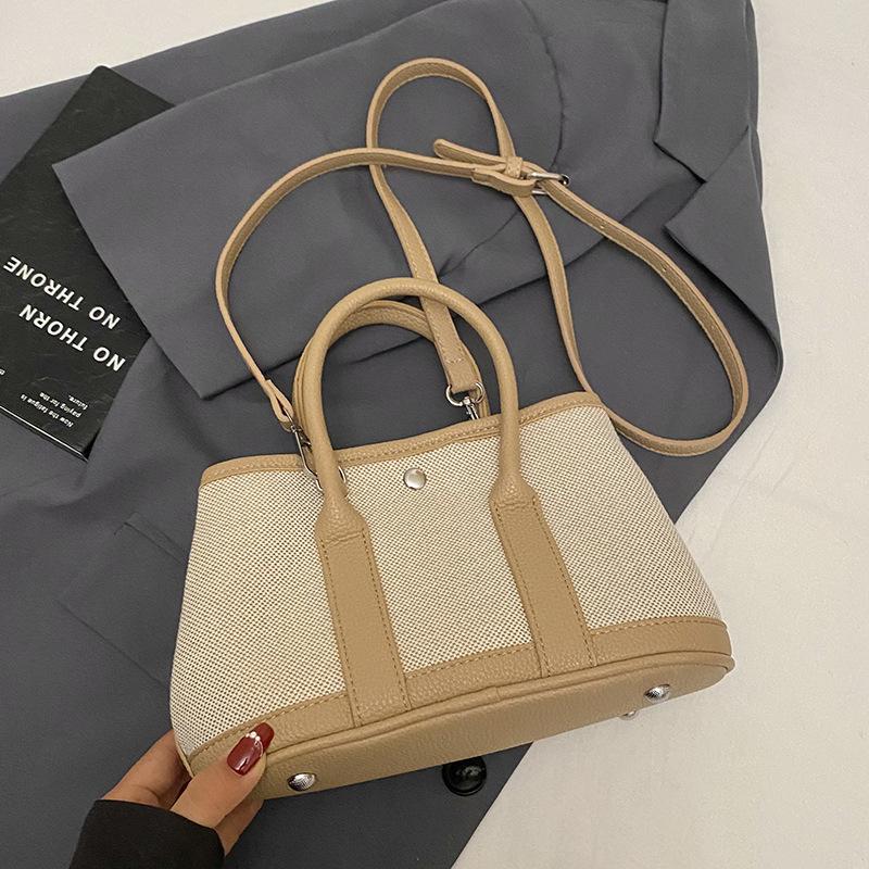Korean version of casual niche contrasting color splicing portable bucket bag fashion versatile temperament casual commuter messenger bag woman