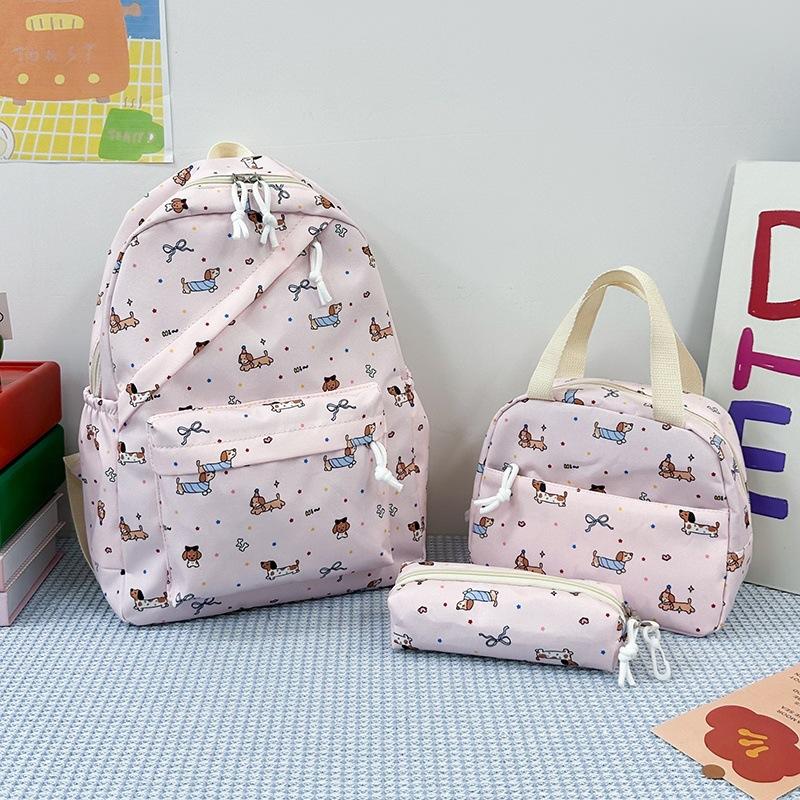 New cartoon printed women's schoolbag, junior high school and primary school students reduce the burden of three-piece backpack, large-capacity