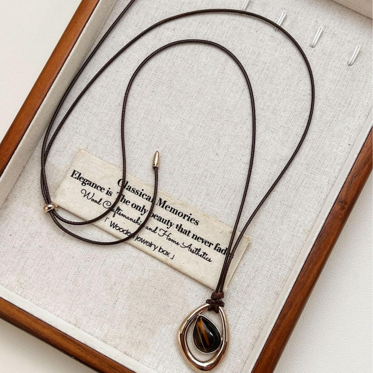 

Irregular teardrop tiger s eye pendant necklace, vintage and unique.