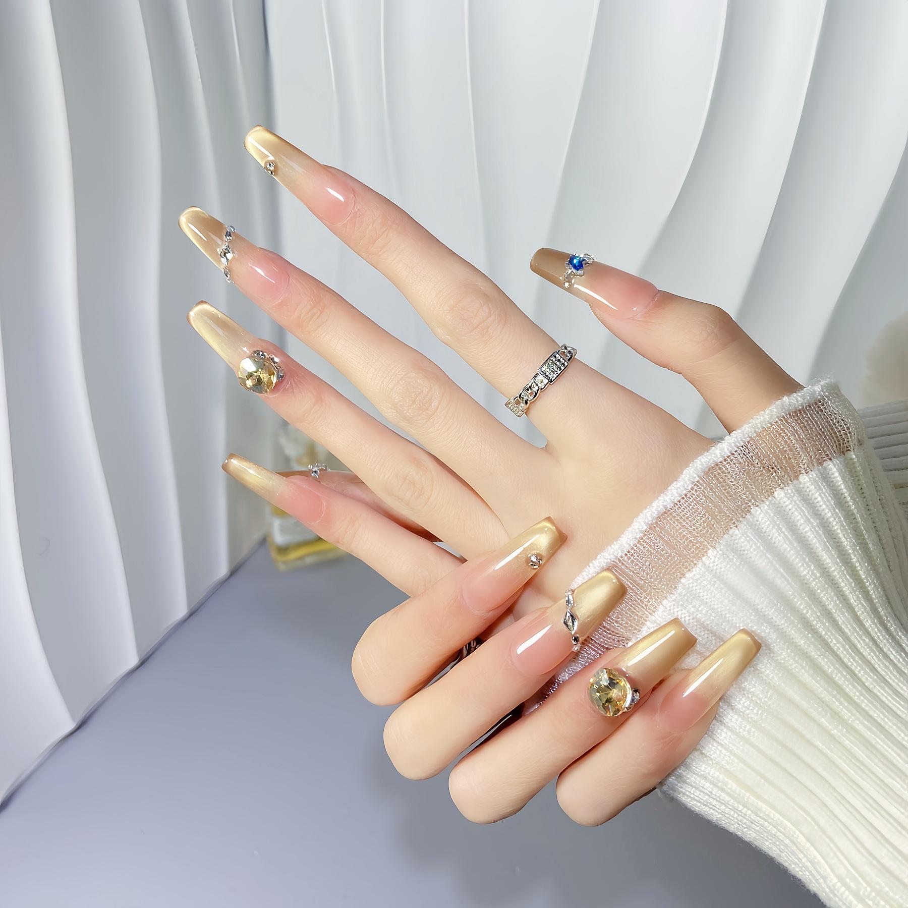 Gemstone Diamond Press-On Nails: Luxurious Gold Nude Gradient with Cat Eye and Whitening Effect.