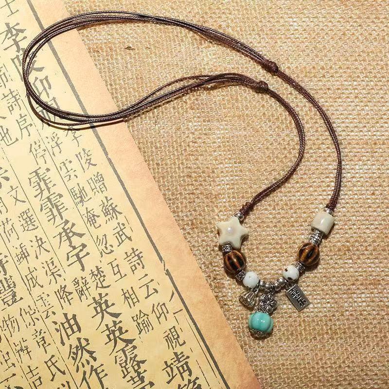 Retro pendant, ethnic style ceramic butterfly bell necklace, women's new trendy long sweater chain with accessories