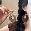 New Chinese wood hollow round pendant earrings fashionable retro simple ear hook niche high-end earrings