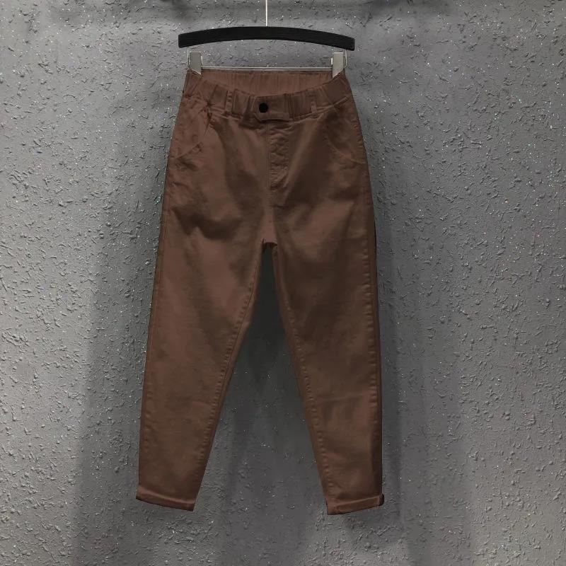 

Жіночі літні та осінні штани Haren. Універсальні повсякденні бавовняні джинсові штани. На еластичній талії. Однотонні довгі джинси. M коричневий