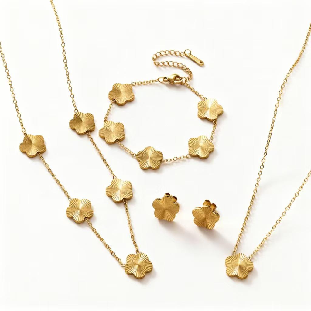 Gold-Plated Titanium Steel Four-Leaf Clover Jewelry Set: Necklace, Bracelet & Earrings for Women – Luxurious High-End Feel.