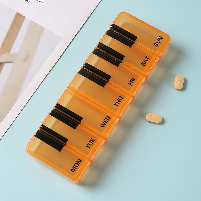 

Portable 7-Day Piano Key Medicine Box For Storing Medicines For A Week With Multiple Compartments To Prevent Odor Contamination