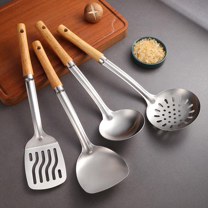 Stainless Steel Cookware Set: Spatula, Soup Ladle, Slotted Spoon with Orange-Brown Wood Handle.