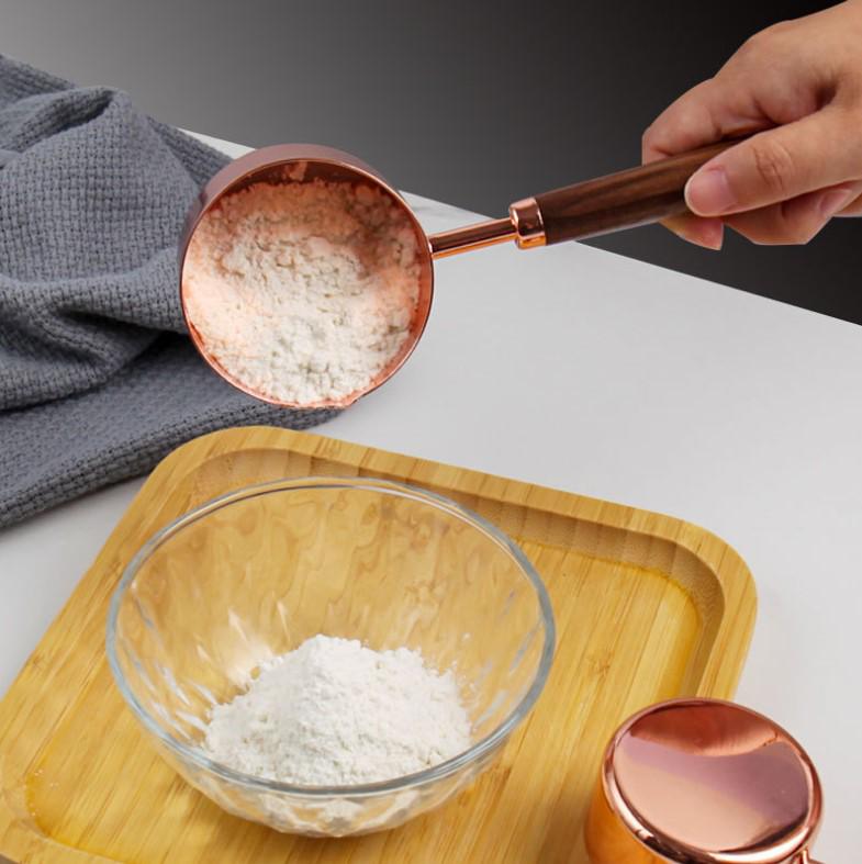 Gold-Plated Stainless Steel Measuring Cups & Spoons with Solid Wood Handles and Scale Markings for Baking.