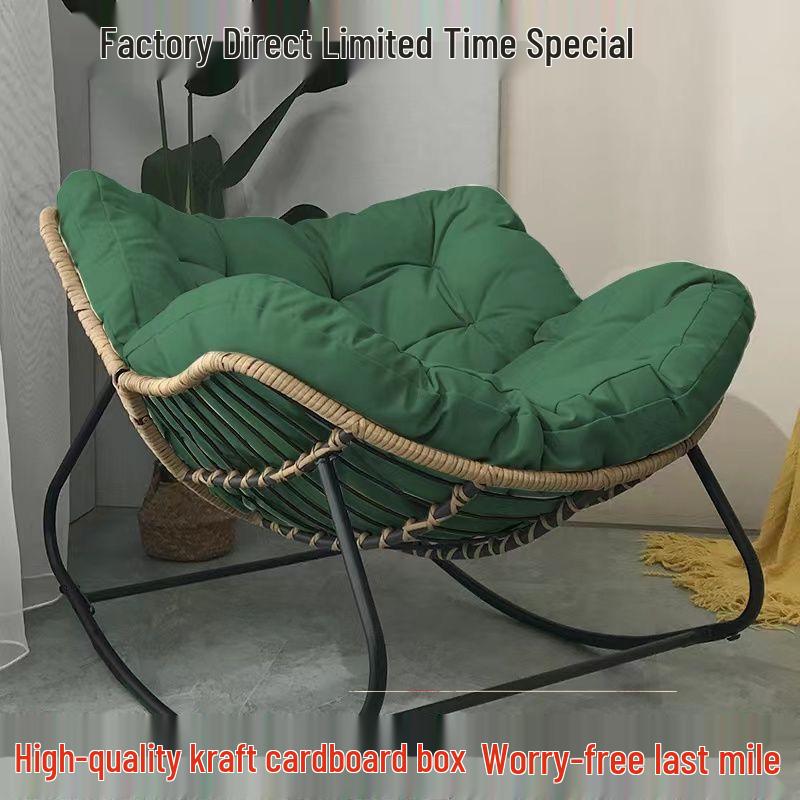 Rattan Rocking Chair: Comfortable Indoor/Outdoor Lounge with a Wrought Iron Frame.