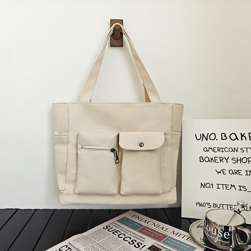 

Large capacity canvas bag women s 2025 spring new fashion casual shoulder women s bag double pocket commuter tote bag білий