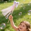 Tooth Fairy Wand with Smiling Tooth Design and Attached Ribbon Streamers on Wooden Stick for Themed Events and Decorations