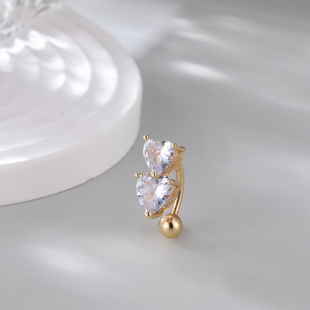 

Популярный пирсинг пупка в виде двойного сердца со стразами — европейский и американский стиль