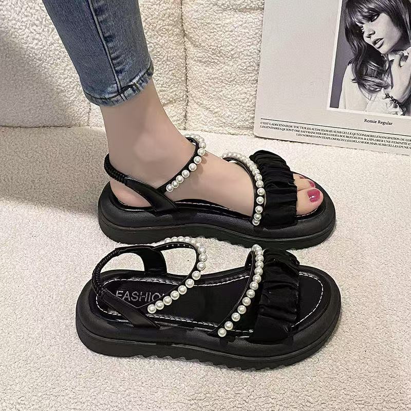Stepping on shit sandals women's summer 2025 new beach shoes ins trendy fairy wind flat bottom wear non-slip Roman sandals