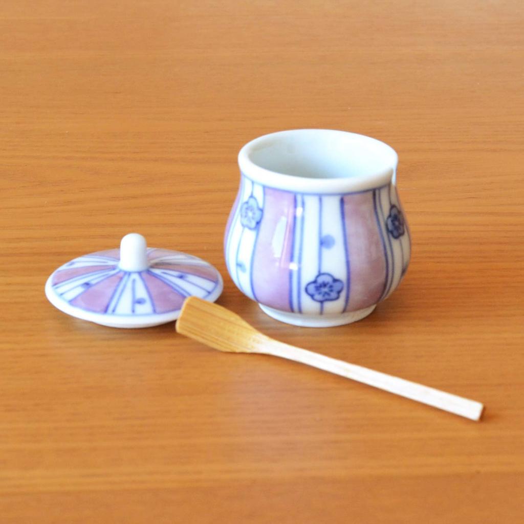 Stylish ceramic condiment container with lid and bamboo perfect for home or commercial Made in Japan by Arita featuring a chestnut plum spoon, use.