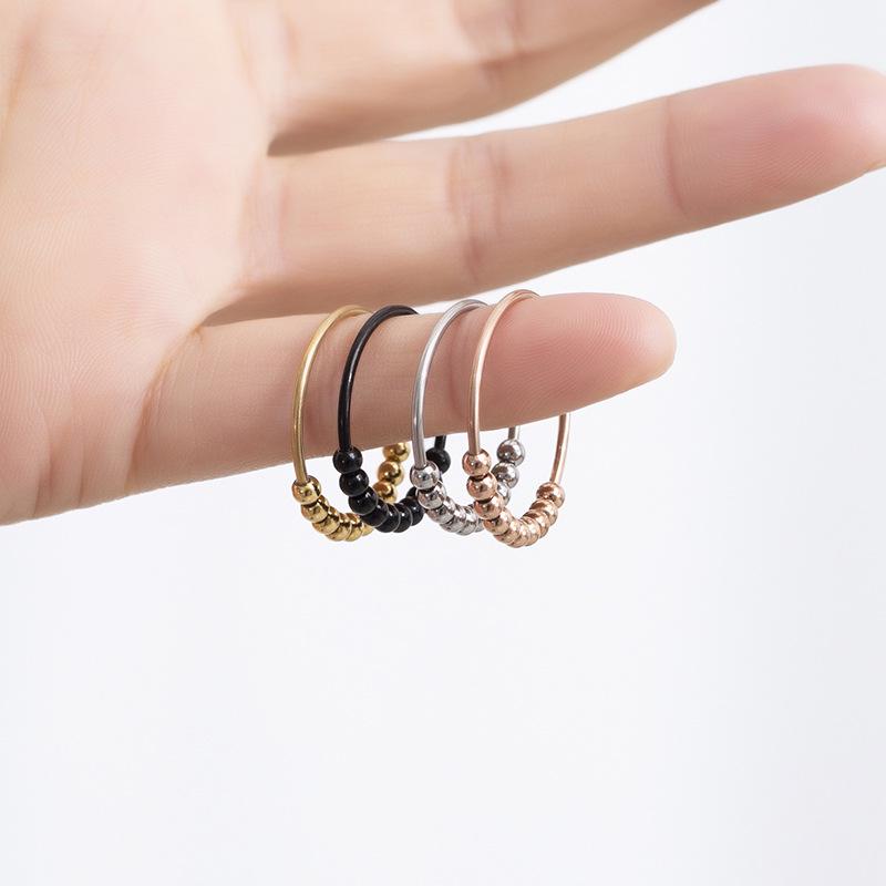 Neuer drehbarer Stressabbau-Angstring mit Perlen