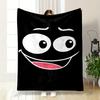 A Cartoon-style Smiling Face with Big Eyes On a Black Background. for All Seasons Blanket Lunch Break Throw Gift