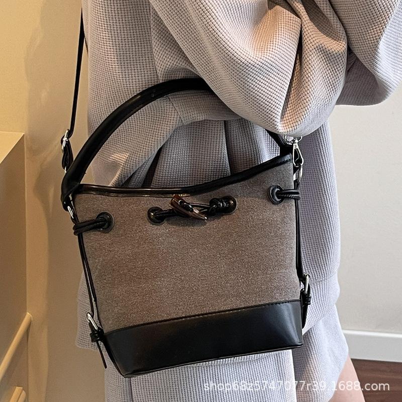 2025 new niche design canvas portable bucket bag women's simple high-end commuter shoulder messenger women's bag