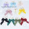 Large Bow Faux Pearl Bracelet Keychain with Colored Woven Strap and Alloy Tag Pendant