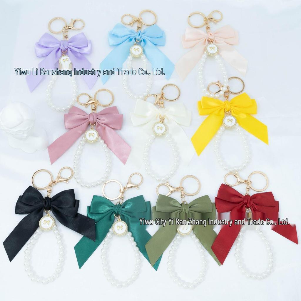 Large Bow Faux Pearl Bracelet Keychain with Colored Woven Strap and Alloy Tag Pendant