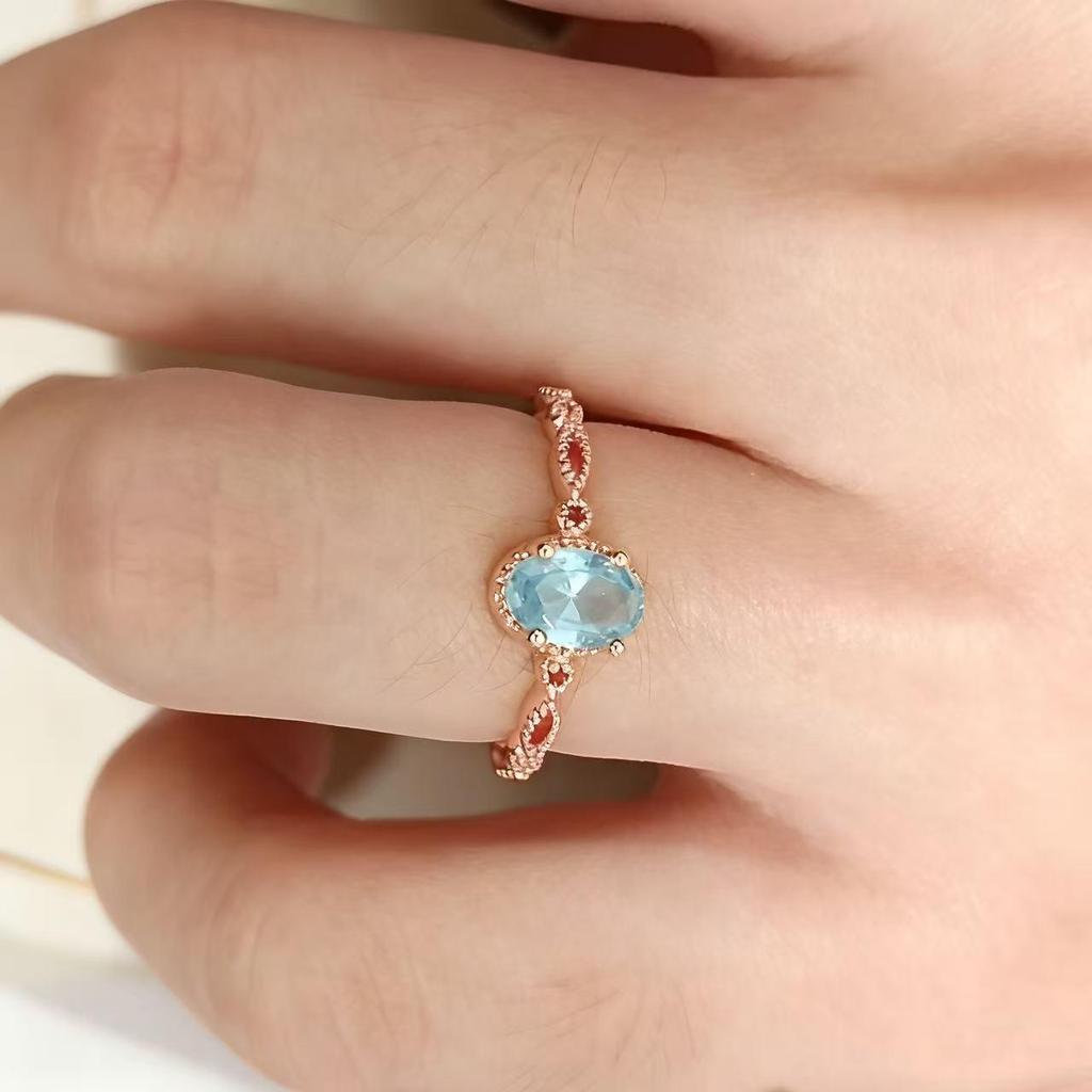 Anillo Yintai de Oro Rosa con Topacio Azul, Circonita Ovalada y Banda Trenzada - Exquisita Joyería de Lujo Ligero
