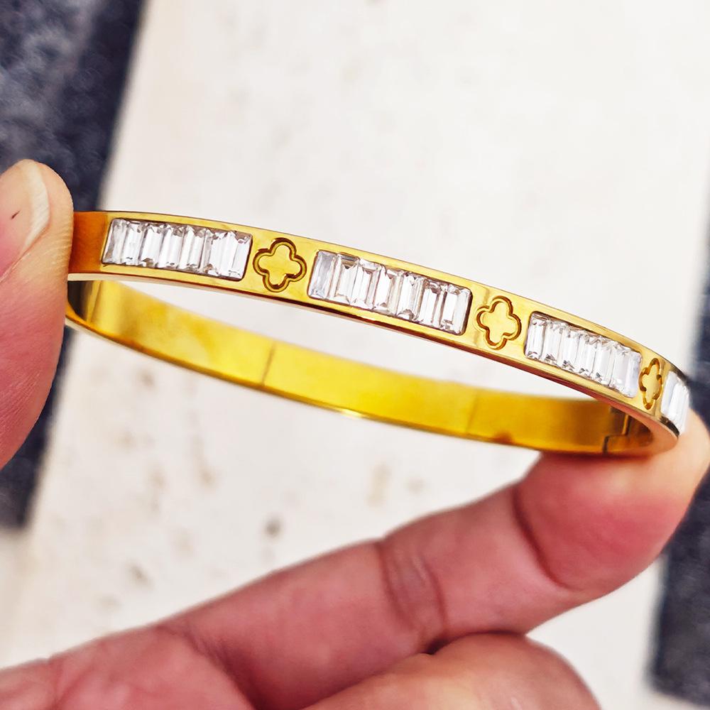 Gold Heart-Shaped Stainless Steel Bracelet with Embroidered Bow and Tassel Woven Cord.