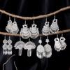 Bohemian Ethnic Miao Silver Tassel Earrings with Butterfly, Peacock, and Flower Design for Women – Long Dangle Jewelry for Travel Photos.