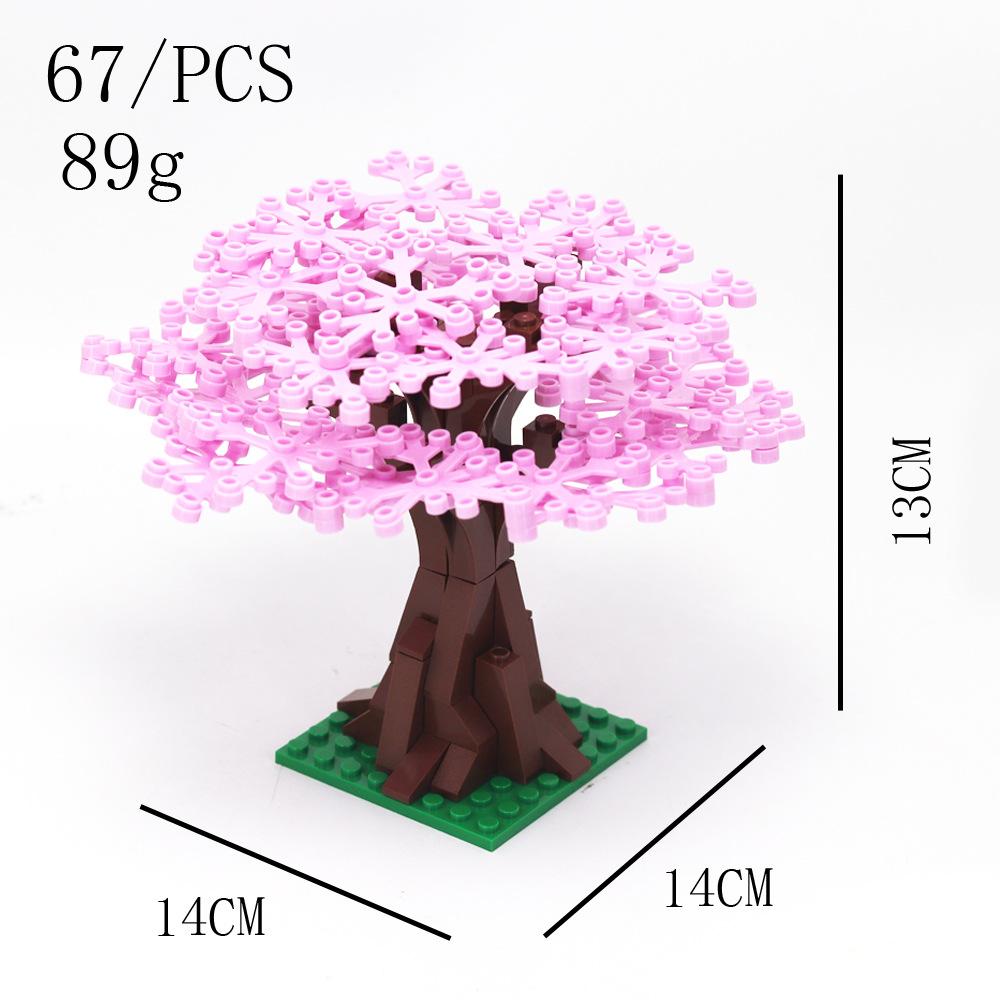 

Строительные блоки из мелких частиц собирают большую сцену баньяна, чтобы построить орнаменты из листьев растений
