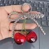 Cherry Pendant Keychain With Bowknot Fashionable Cherry Keychain with Pearlescent Bowknot Accents for Trendsetters