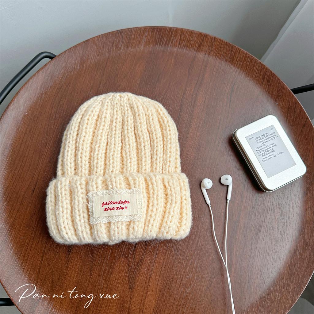 Neue Spitze Etikett Kinder Wollmütze Nuojiji Student Herbst und Winter Neu Warm und Vielseitig Ohrenschutz Strickmütze
