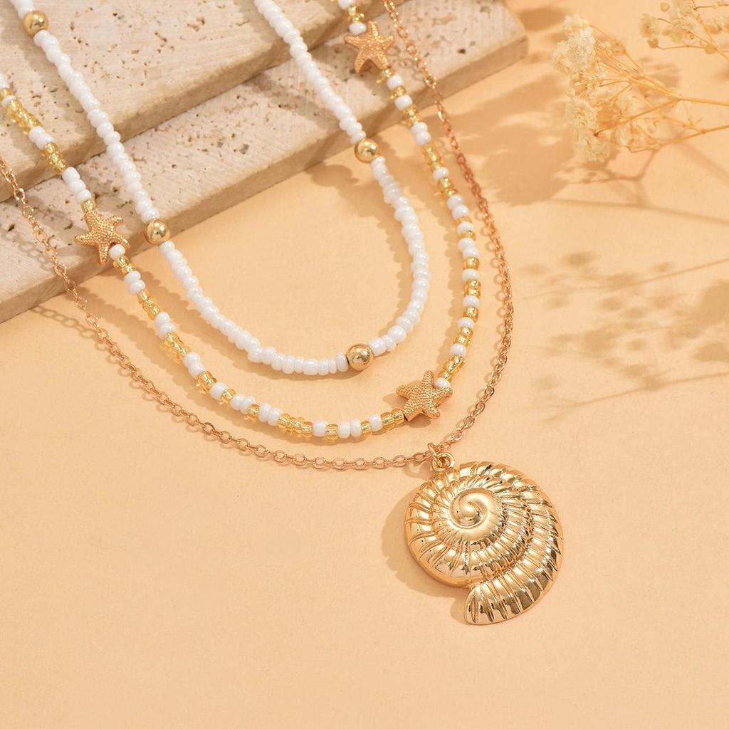 Starfish & Conch Pendant Necklace - Versatile Fashion Jewelry with Rice Bead Clavicle Chain for Women.