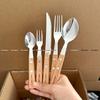 Stainless Steel Cutlery Set with Wood Handles and Smiley Logo - Knife, Fork, Spoon for Desserts and Dining.