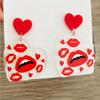 A pair of Valentine's Day acrylic red heart-shaped earrings, sweet personality red lips, niche trend women's earrings.