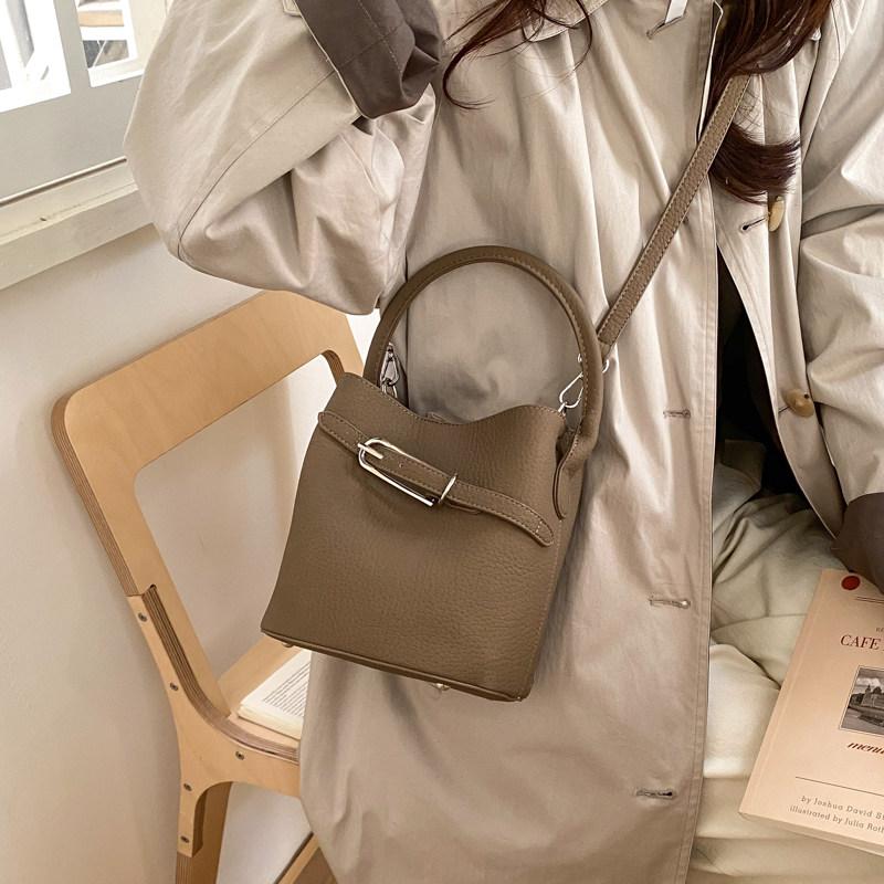 Soft Leather Bucket Bag for Women 2026 New Solid Color Buckle Handbags Simple Lychee Pattern Commuting Crossbody Bags
