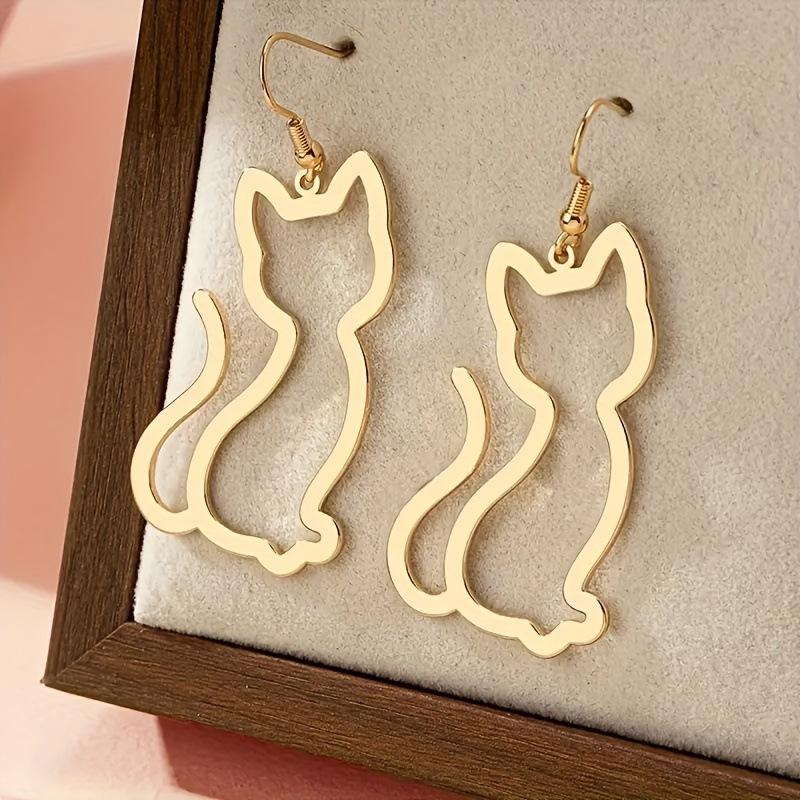 Пара желтых полых серег-кошек с минималистичным дизайном золотой