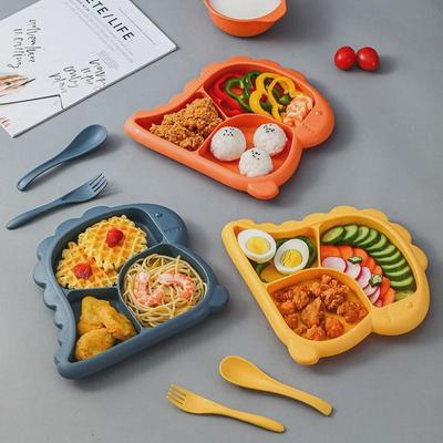 Set per l'alimentazione dei bambini con dinosauri dei cartoni animati creativi: Include piatto spesso, ciotola, cucchiaio e forchetta adatti ai neonati e all'asilo.