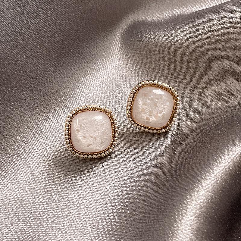 Silver Needle White Heart Tassel Earrings: Luxurious, Versatile, and Stylish Stud Earrings for Women.