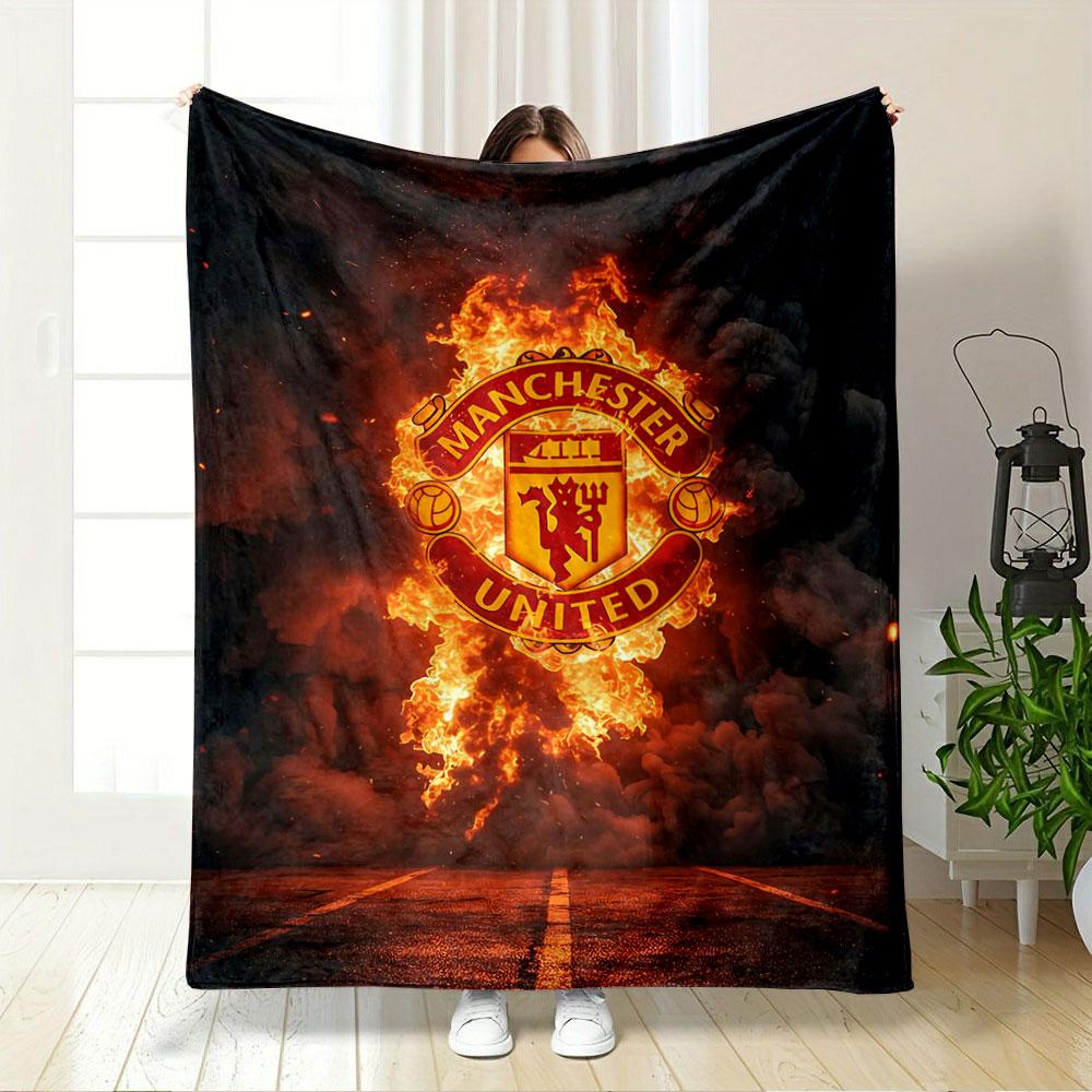 A Fiery Manchester United Logo Emerges Against Smoke and a Dark Background. for All Seasons Blanket Lunch Break Throw Gift