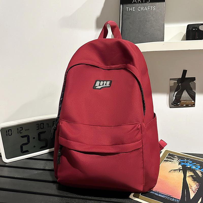 

Студенческий рюкзак Рюкзак для ученика средней школы Рюкзак для ученика начальной школы Большой вместимости Высокая ценность Однотонный школьный рюкзак Новый красный