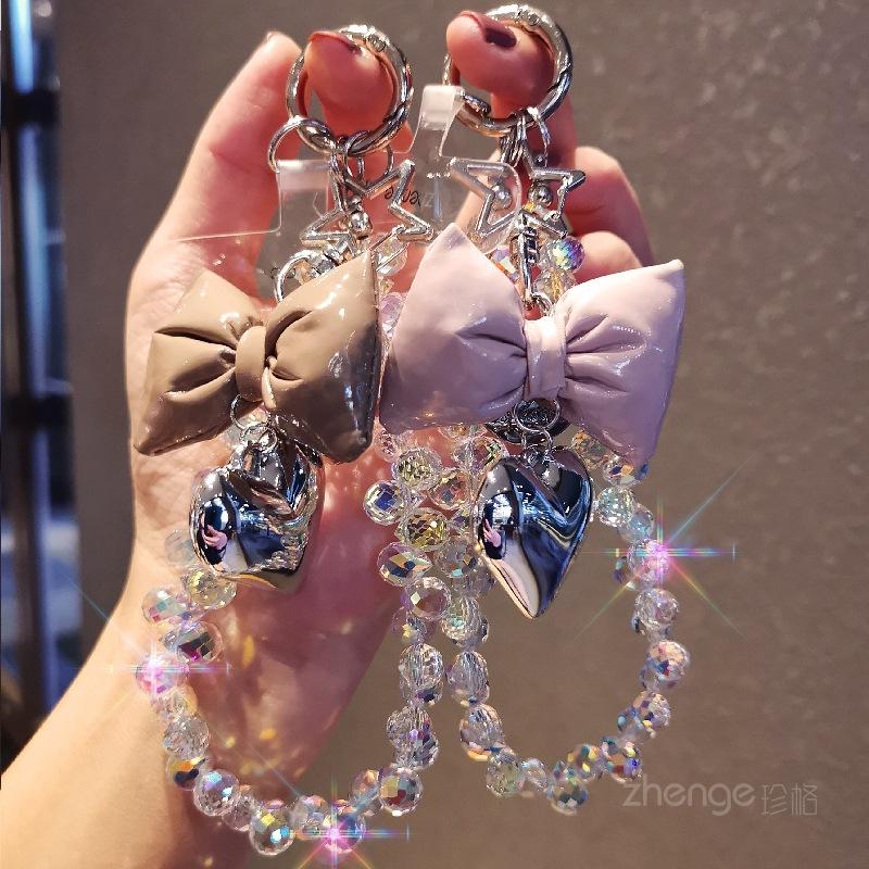 Small fragrance bow tie, love mobile phone hanging chain, ins mobile phone case, pendant, beaded chain, short fashion women's wrist ornament