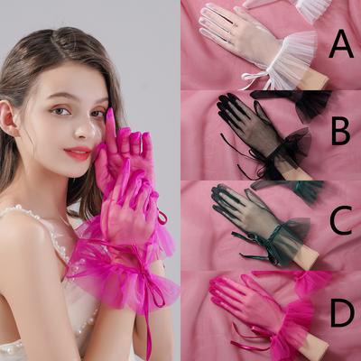 Une paire de gants en maille transparente de style doigt jusqu'au poignet, adaptés comme accessoires pour les mariages de mariées ou les danses de femmes