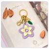 Marque de Luxe Sac Fleur Pendentif Mode Élégant Métal Cuir Créatif Exquis Polyvalent Mignon Accessoires Sac Porte-clés