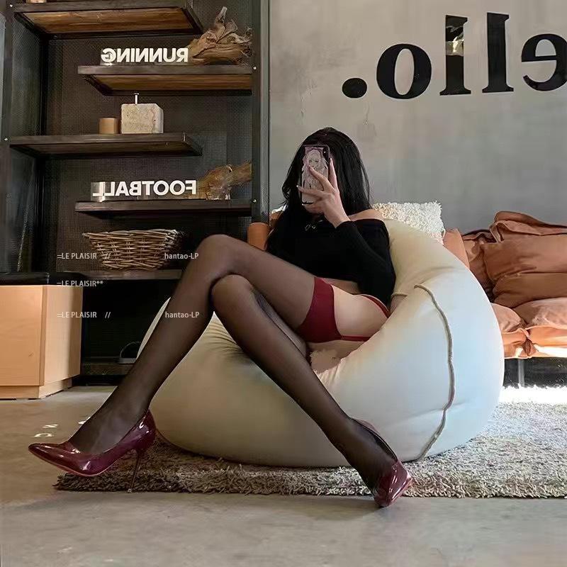 Elegantly crafted black silk suspender lace stockings with polka dot bow and over-the-knee design.