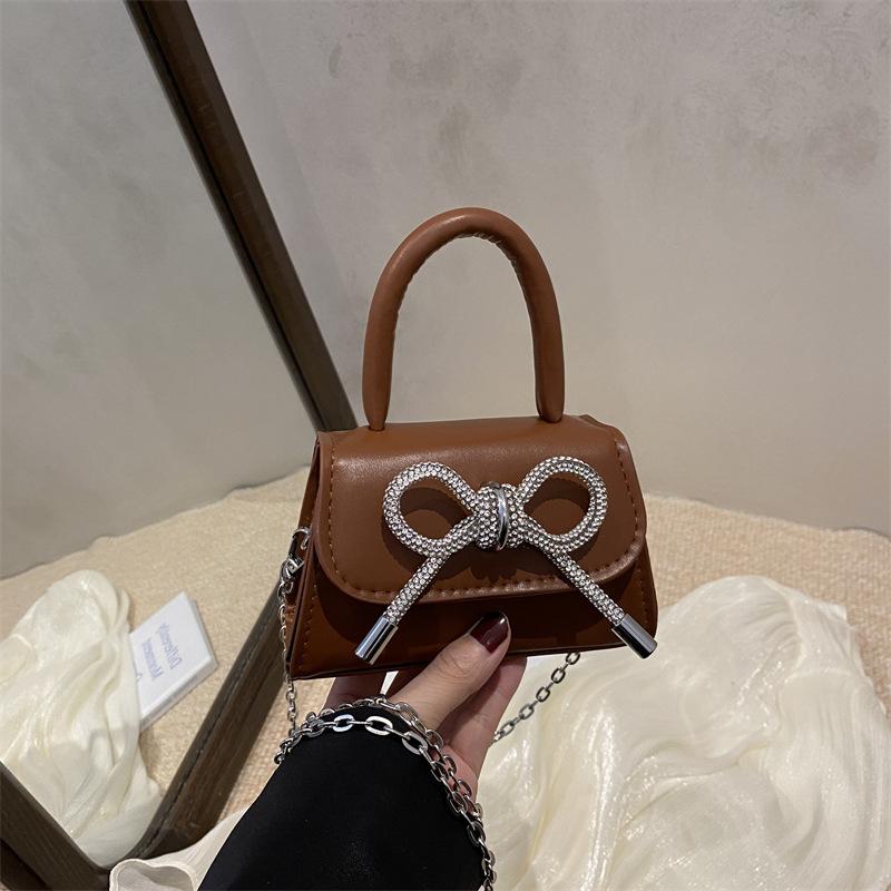 2026 Fashi Women's Mini PU Leather Handbag with Metal Chain Strap&Oversized Bow Top Handle Crossbody Bag for Decorative Purse