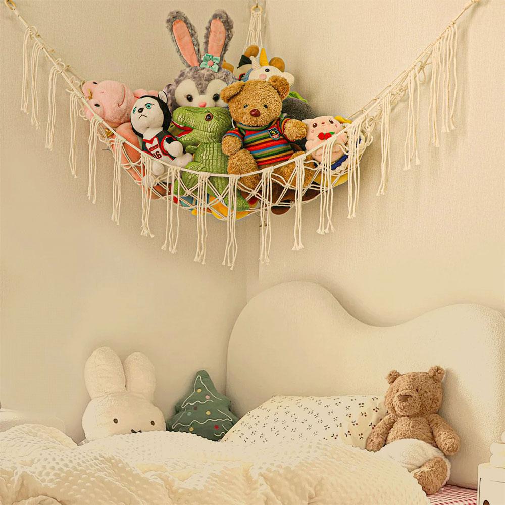 Toy hammock is hung in the corner and is equipped with a storage net, a toy storage bag, and a wall-mounted hammock.