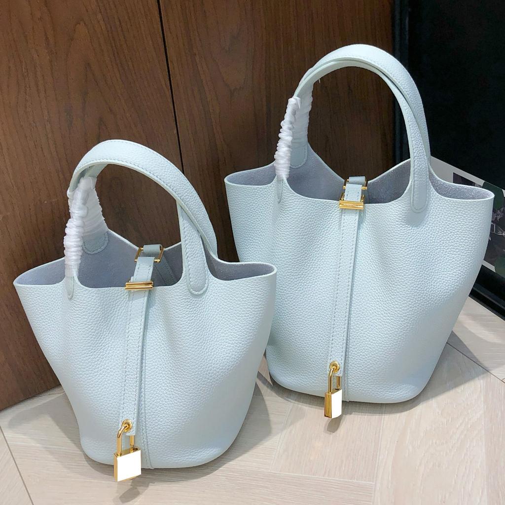 2025 New Style Top Layer Cowhide Vegetable Tanned Leather Bag Sun Blue Water Bottle Bag Togo Leather Handheld Clutch Shoulder Bag Womens Bag