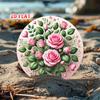 A round sign adorned with a bunch of pink roses and green leaves this sign can be used as floral wall decor